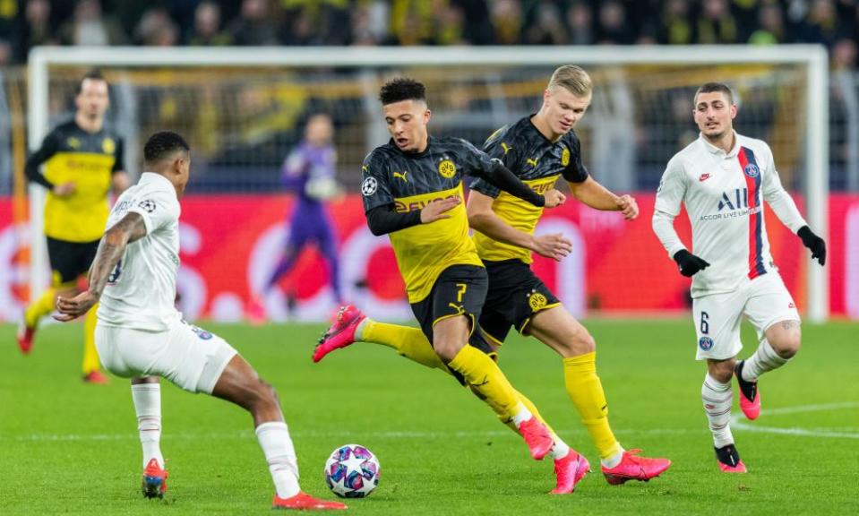 Jadon Sancho (centre left) and Erling Haaland (centre right) in action against PSG in February 2020.