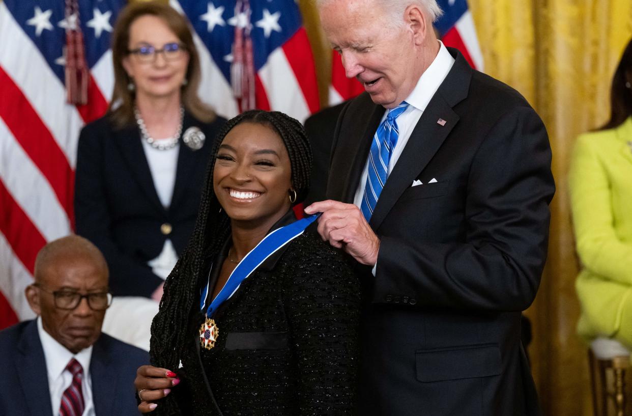 US President Joe Biden presents Gymnast Simone Biles with the Presidential Medal of Freedom, the nation's highest civilian honor, during a ceremony honoring 17 recipients, in the East Room of the White House in Washington, DC, July 7, 2022. (Photo by SAUL LOEB / AFP) (Photo by SAUL LOEB/AFP via Getty Images)