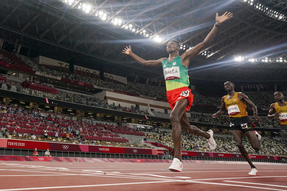 Selemon Barega, of Ethiopia, celebrates after winning the men's 10,000-meter run at the 2020 Summer Olympics, Friday, July 30, 2021, in Tokyo. (AP Photo/David J. Phillip)
