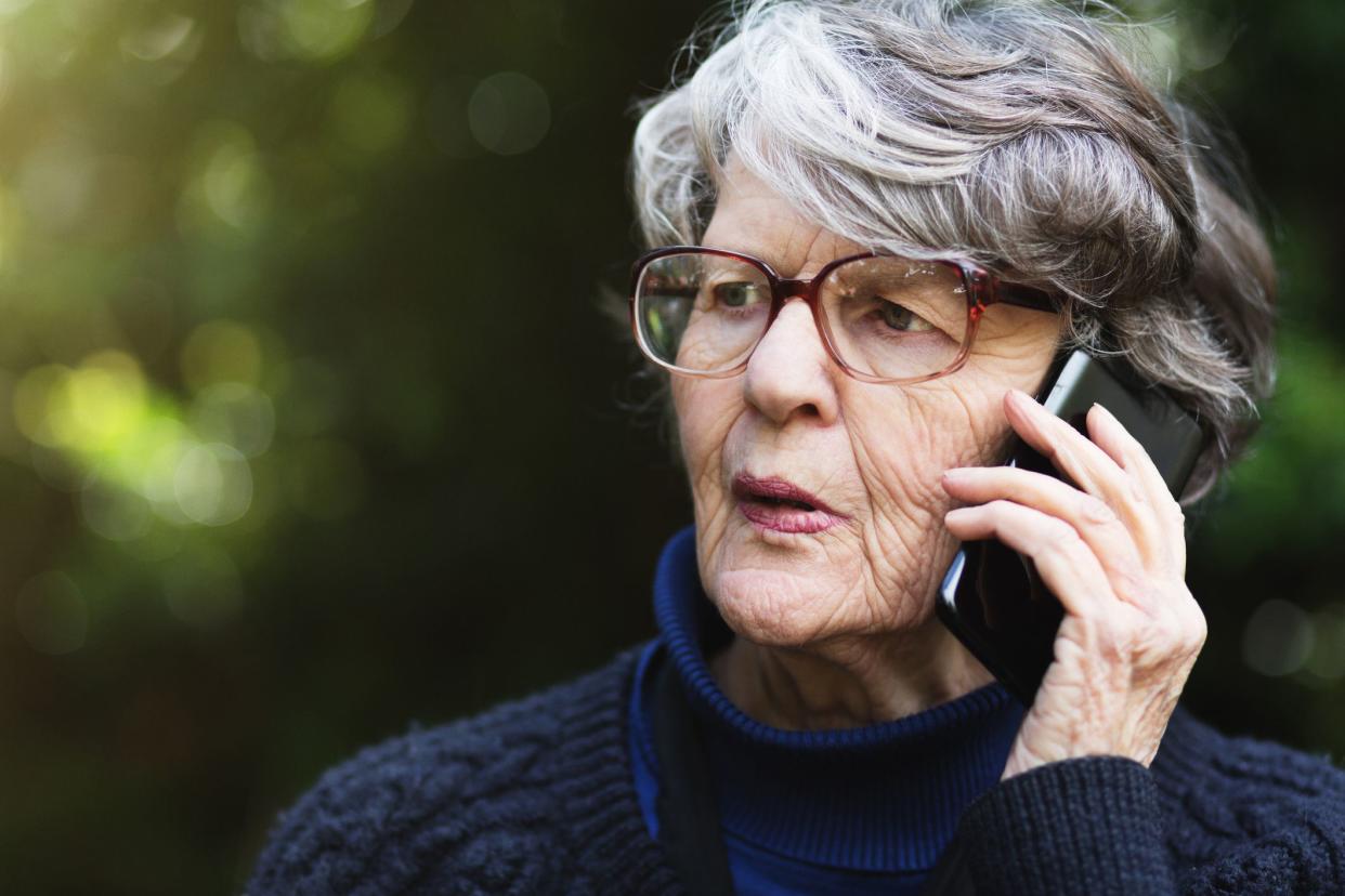 woman on phone with nervous expression