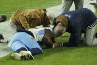 Tennessee Titans wide receiver Treylon Burks is checked out by the team's medical staff after being injured during the second half of an NFL football game against the Pittsburgh Steelers, Thursday, Nov. 2, 2023, in Pittsburgh. (AP Photo/Matt Freed)