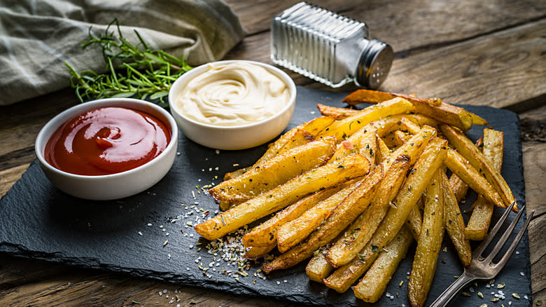 Seasoned French fries with sauces on side