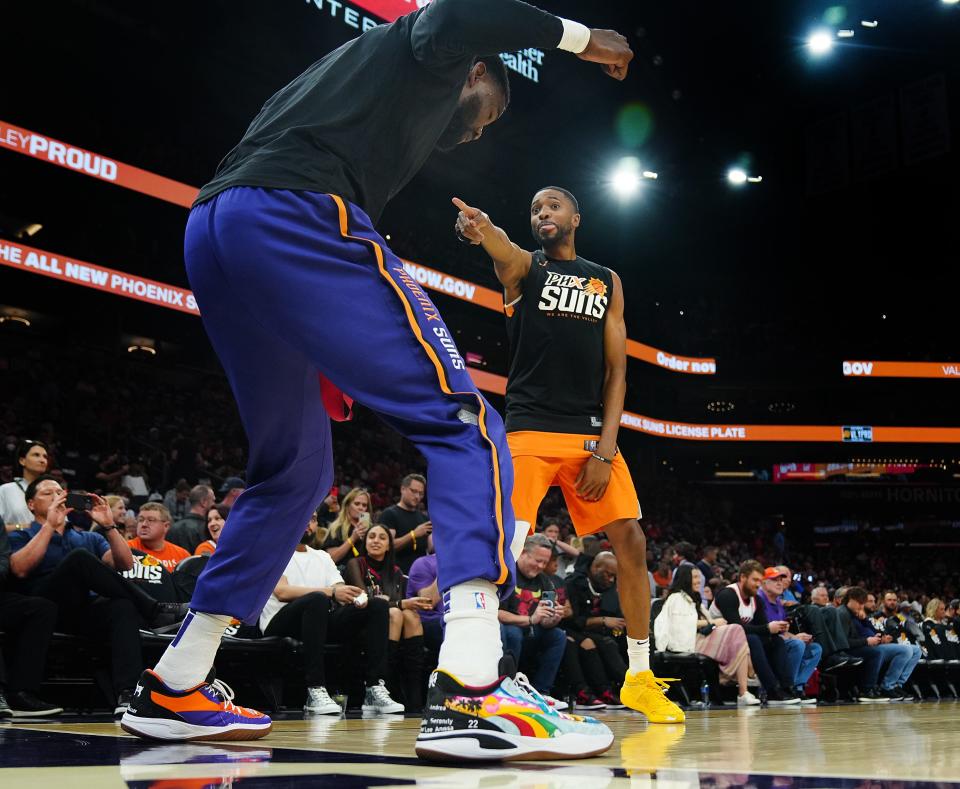 Mar. 18, 2022;  Phoenix, AZ, USA; Suns' Deandre Ayton (L) and Mikal Bridges (25) dance before the game against the Bulls at the Footprint Center.