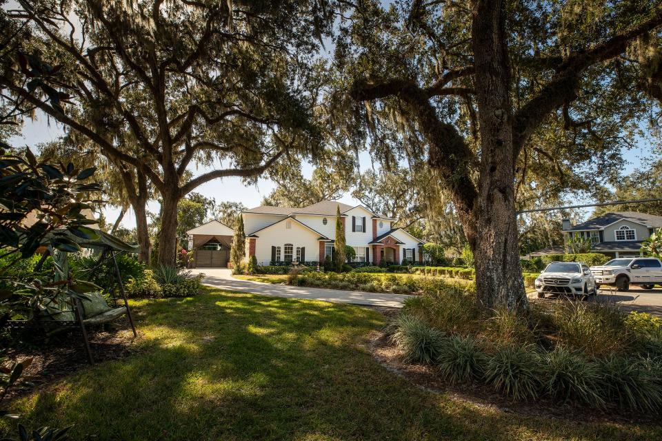 The carport for a motorhome at the back of Alyne Aca's driveway as seen from the street in front of her home in the Longwood Oaks neighborhood in South Lakeland. Disputes over her building of the enclosure have led to a lawsuit against her and a subsequent lawsuit against the HOA board.