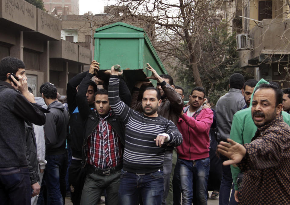 Egyptians carry the coffin of a man killed during Saturday's clashes between protesters and security forces near the Zeinhom morgue in Cairo, Egypt, Sunday, Jan. 26, 2014. Egyptian officials said Sunday that the death toll from clashes between security forces and protesters on the third anniversary of the country's 2011 uprising has risen to 49. (AP Photo/Aly Hazzaa, El Shorouk) EGYPT OUT