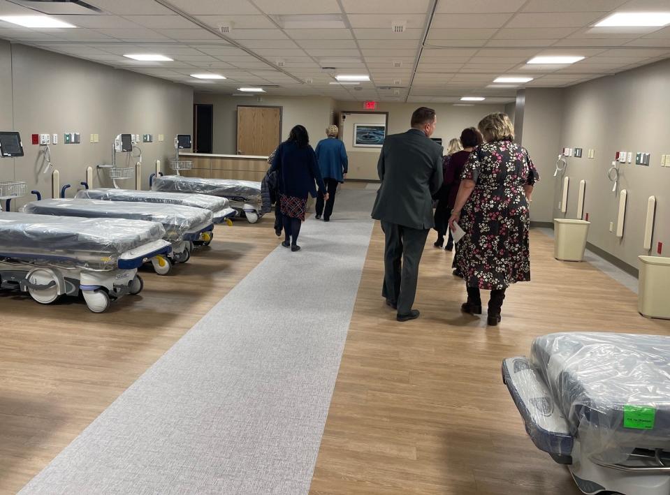 Chief Nursing Officer Kris O'Shea, background center, leads a group of visitors through the new recovery room in the hospital's Cardiovascular and Surgical Care Pavilion.