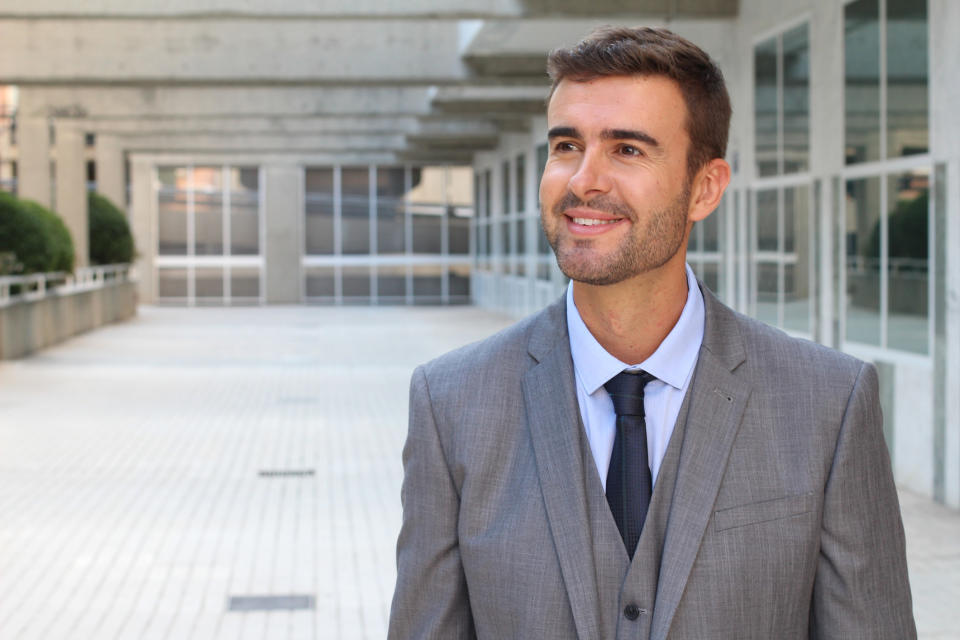 A man in a suit smiling