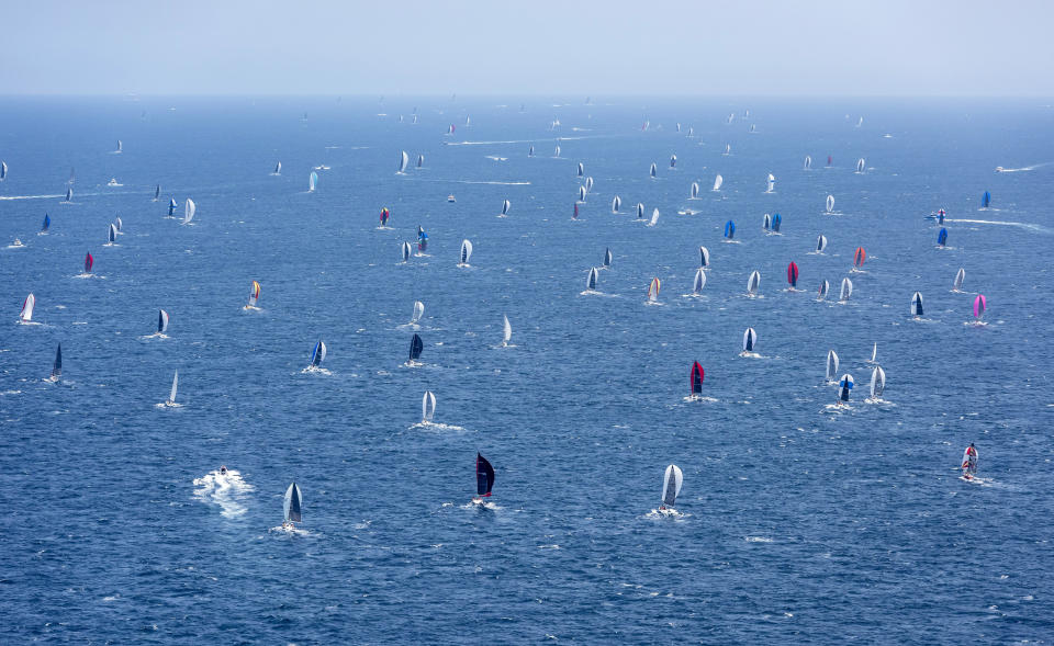 Competitors begin their journey south after the start of the 75th Sydney Hobart yacht race in Sydney Harbour, Thursday, Dec. 26, 2019. (Rolex/Kurt Arrigo via AP)