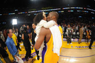 Kobe Bryant #24 of the Los Angeles Lakers kisses his daughter Gianna after converting a last-second shot to defeat the Sacramento Kings 109-108 at Staples Center on January 1, 2010 in Los Angeles, California. (Photo by Noah Graham/NBAE via Getty Images)