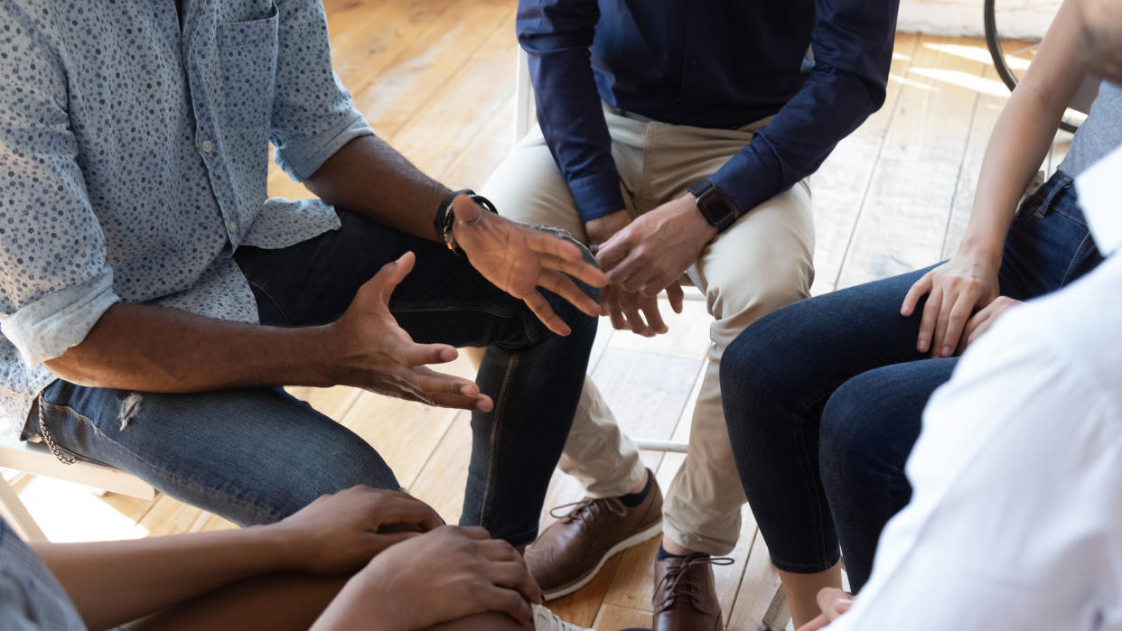 Suicide prevention: Man counselor therapist coach psychologist speak at group counseling therapy session concept encourage support patients in addiction talk share problem sit in circle in rehab, close up view. (Getty Images)