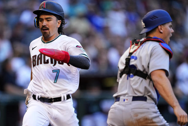 Arizona Diamondbacks' Lourdes Gurriel Jr. (12) celebrates his RBI double  against the Los Angeles Dodgers during the first inning of a baseball game,  Saturday, April 8, 2023, in Phoenix. (AP Photo/Matt York