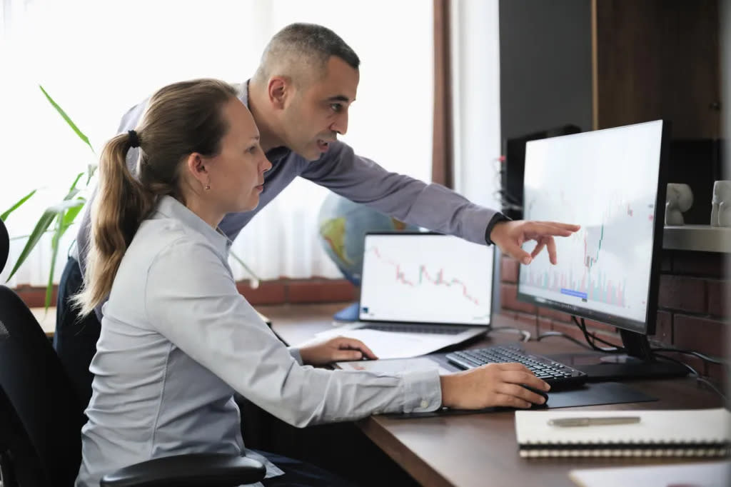 Two investors reviewing a portfolio.