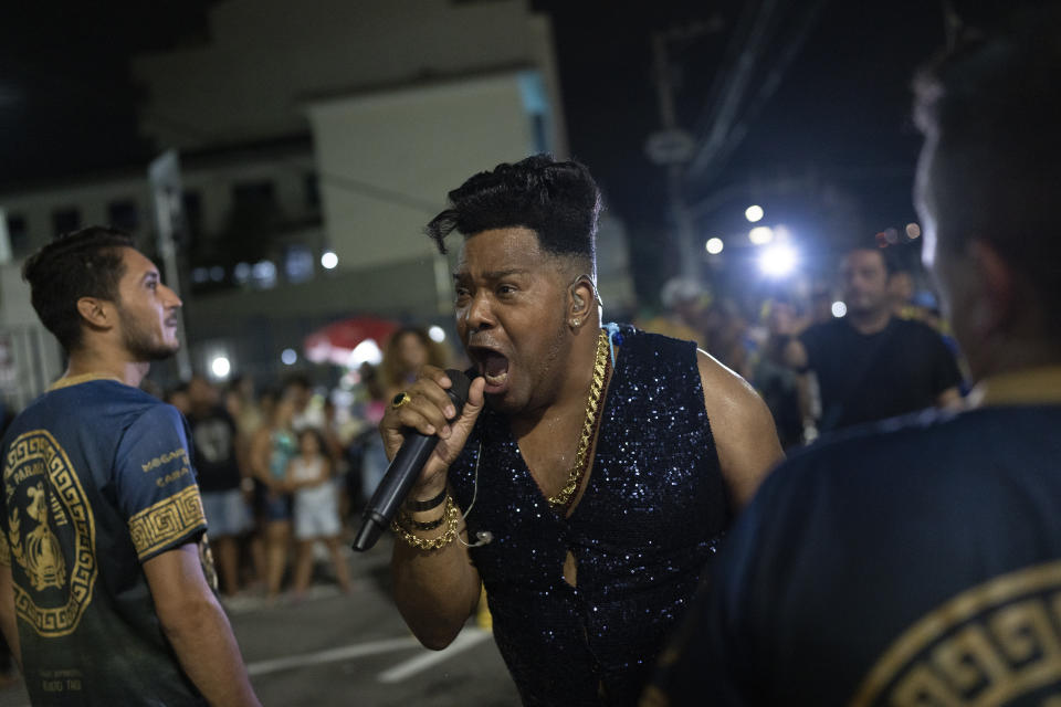 A member of Paraiso do Tuiuti samba school sings during a rehearsal in the streets ahead the Rio de Janeiro's Carnival Parade, in Rio de Janeiro, Brazil, Monday, Feb.6, 2023. (AP Photo/Silvia Izquierdo)