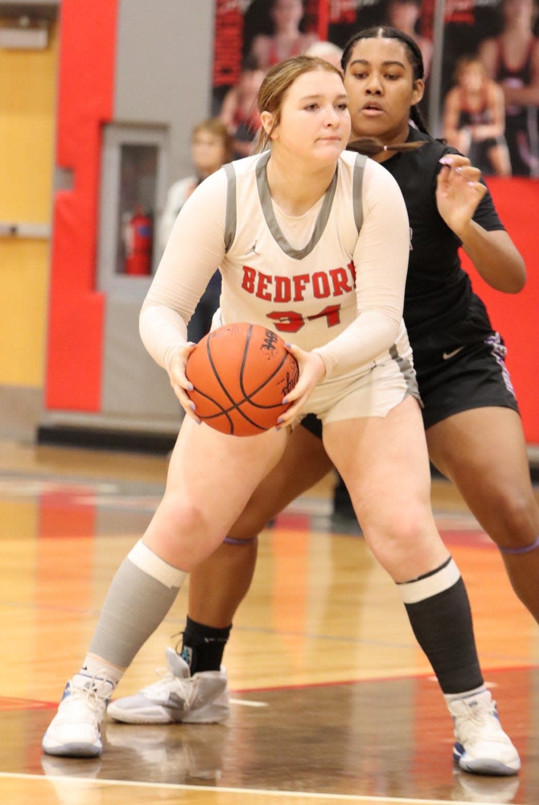 Nyah Mullins shields off a defender during a 37-32 victory over Ann Arbor Pioneer Tuesday night that wrapped up the outright Southeastern Conference Red championship.