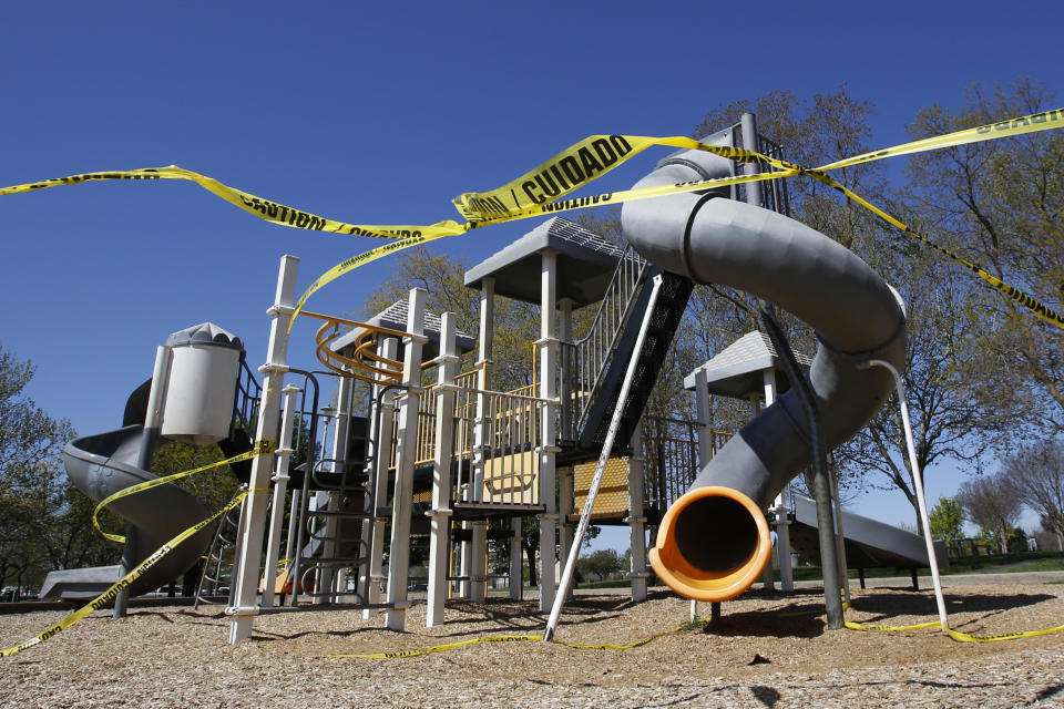 Caution tape surrounds the playground at Country Side Community Park in Elk Grove, Calif., Thursday, April 2, 2020. California has been under a mandatory stay-at-home order for more than a week to help curb the spread of the coronavirus. (AP Photo/Rich Pedroncelli)