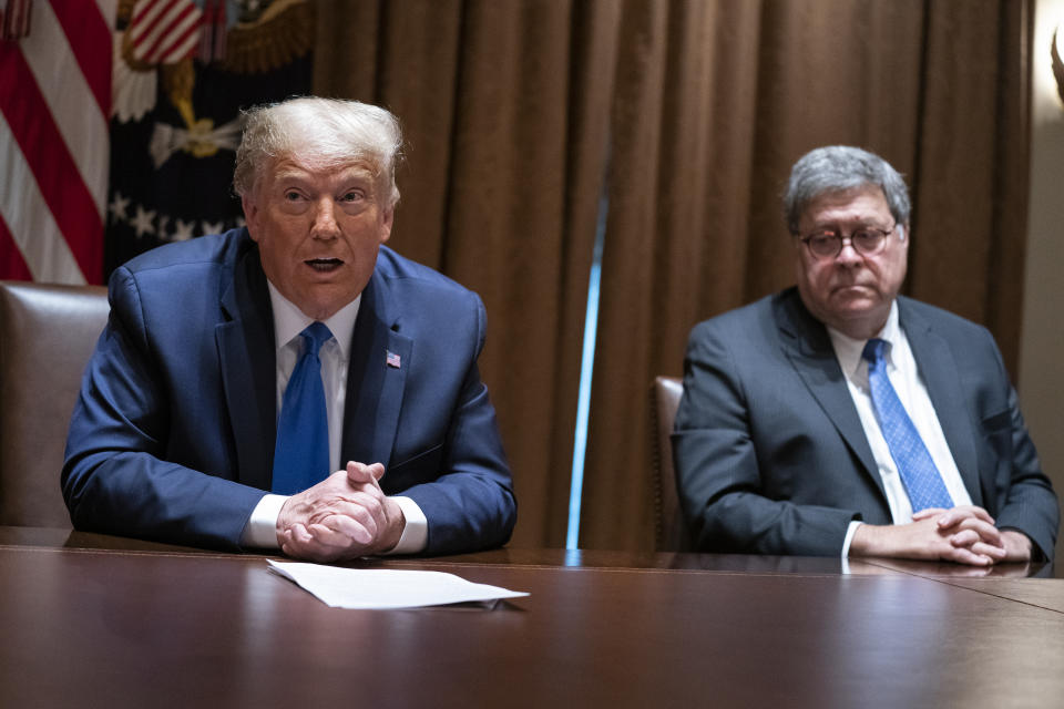 FILE - In this Sept. 23, 2020, file photo Attorney General William Barr listens as President Donald Trump speaks during a meeting with Republican state attorneys general in the Cabinet Room of the White House in Washington. The relationship between President Donald Trump and top ally Attorney General William Barr is fraying over the lack of splashy indictments so far in the Justice Department’s investigation into the origins of the Russia probe, according to people familiar with the matter. (AP Photo/Evan Vucci, File)