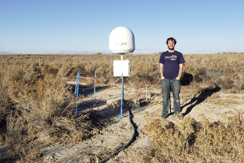 CORRECTS TO NOV. 4 NOT NOV. 5 - This undated photo provided by Caltech shows radio astronomer Christopher Bochenek with a STARE2 station he developed near the town of Delta, Utah. On Wednesday, Nov. 4, 2020, astronomers say they used this system and a Canadian observatory to trace an April 2020 fast cosmic radio burst to our own galaxy and a type of powerful energetic young star called a magnetar. (Caltech via AP)