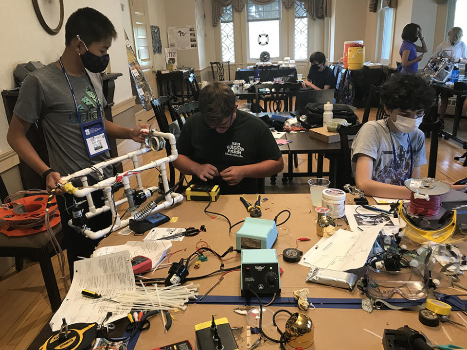 Shipwreck Camp students piece together ROVs to carry cameras underwater or solder together wires for the motors powering propellers on their contraptions. (Patrick O’Donnell)