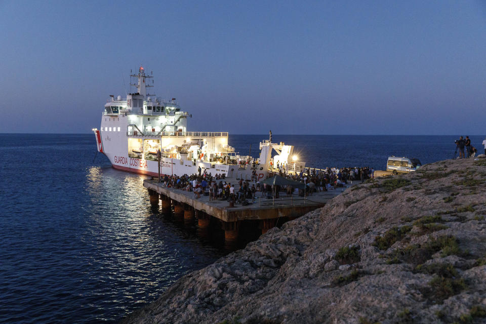 FILE - Migrants wait to board an Italian Coast Guard ship in the Sicilian Island of Lampedusa, Italy, Wednesday, Aug. 3, 2022. Italy’s former firebrand interior minister, Matteo Salvini, is campaigning to get his old job back. Salvini is making a stop Thursday on Italy’s southernmost island of Lampedusa, the gateway to tens of thousands of migrants arriving in Italy each year across the perilous central Mediterranean Sea. (AP Photo/David Lohmueller, File)