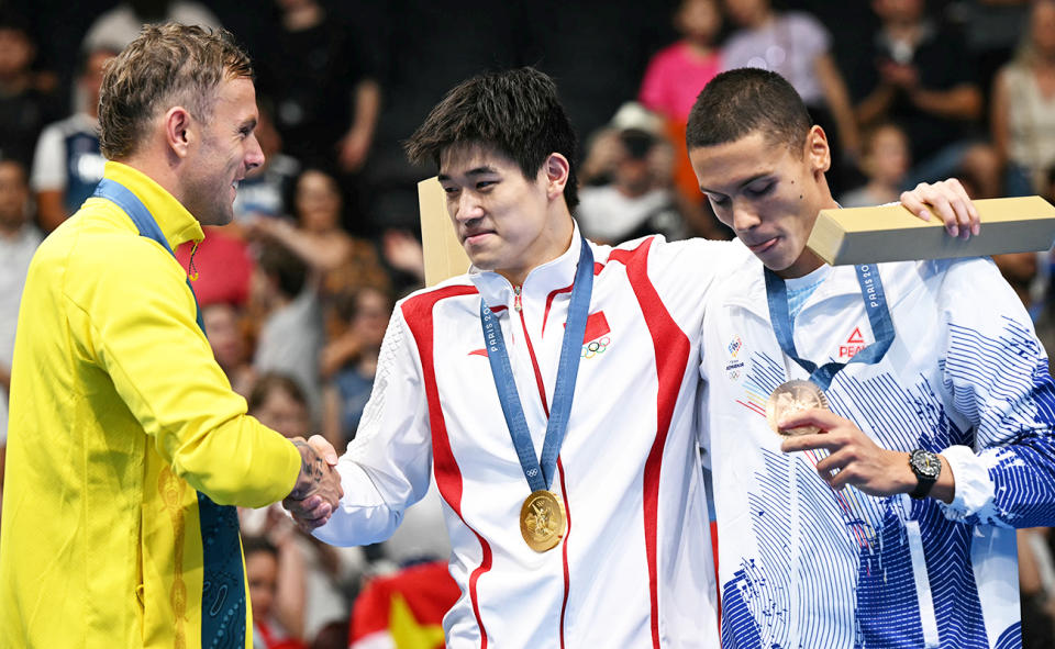 Kyle Chalmers and Pan Zhanle on the podium. 