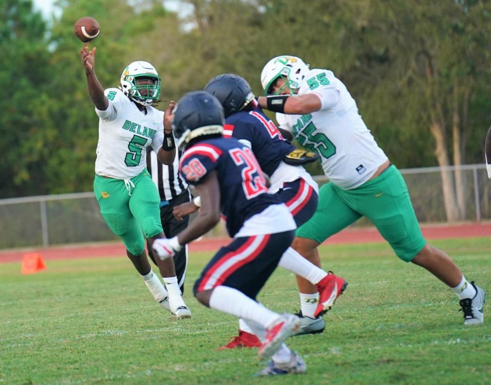 DeLand quarterback TJ Moore (5) rolls out and throws during a game with Centennial on Friday, Sept. 1, 2023. Moore recorded seven touchdown tosses against Deltona Friday.