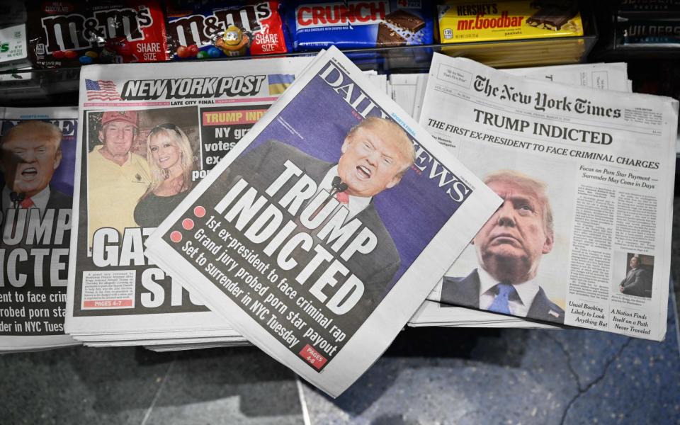 Newspaper front pages covering Donald Trump are displayed at a news stand in New York - Ed Jones /AFP