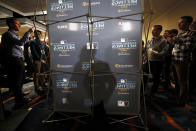 San Francisco Giants manager Gabe Kapler, center, casts a shadow as he speaks with reporters during the Major League Baseball winter meetings, Tuesday, Dec. 10, 2019, in San Diego. (AP Photo/Gregory Bull)