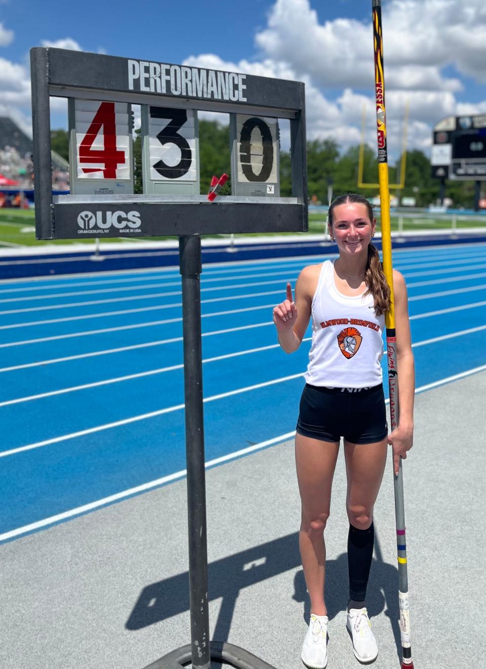 Elmwood/Brimfield junior Mya Strahm poses with her pole and the sign marking her all-class state-record 4.3-meter vault, set Saturday May 18, 2024, at the Illinois High School Association girls track and field meet in Charleston.