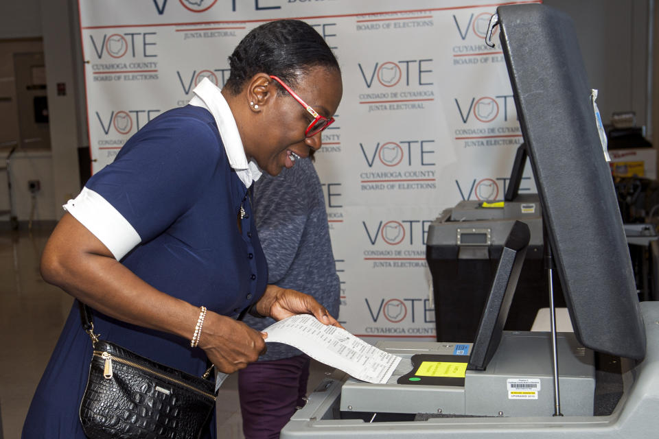 In this July 7, 2021, photo Nina Turner, a candidate running in a special Democratic primary election for Ohio's 11th Congressional District loads her ballot into a tabulating machine at the Cuyahoga County Board of Elections in Cleveland. (AP Photo/Phil Long)