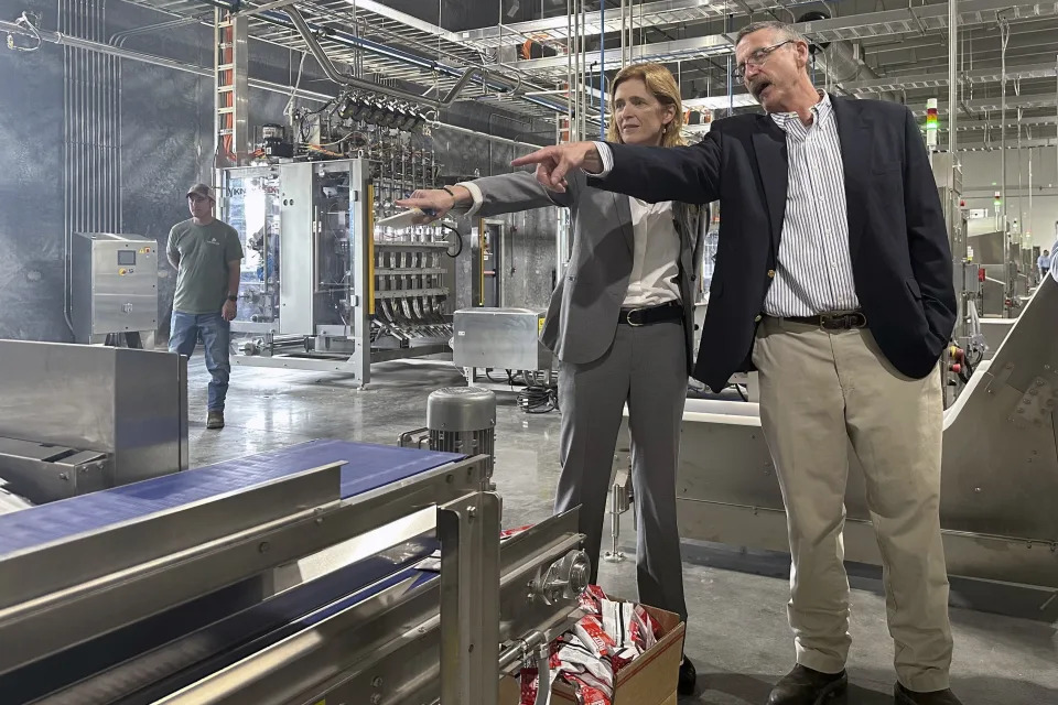 USAID Administrator Samantha Power talks with Mana operations director Harry Broughton during a tour of its factory in Fitzgerald, Ga., that produces emergency nutritional aid for starving children, on Friday, May 3, 2024. Power announced USAID is investing $200 million to increase nutritional aid for starving children in Gaza, Sudan and other places where conflict has increased needs. (AP Photo/Russ Bynum)