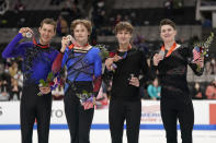 Jason Brown, Ilia Malinin, Andrew Torgashev and Maxim Naumov, from left, hold their medals after the men's free skate at the U.S. figure skating championships in San Jose, Calif., Sunday, Jan. 29, 2023. Malinin finished first, Brown finished second, Torgashev finished third and Naumov finished fourth in the event. (AP Photo/Tony Avelar)