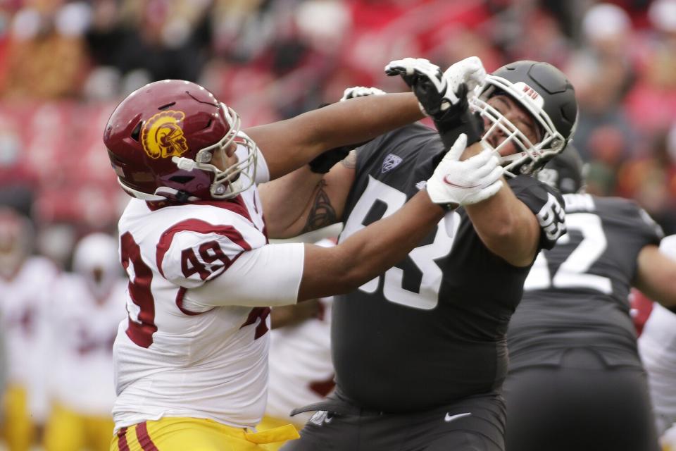 Washington State offensive lineman Liam Ryan blocks USC defensive lineman Tuli Tuipulotu.