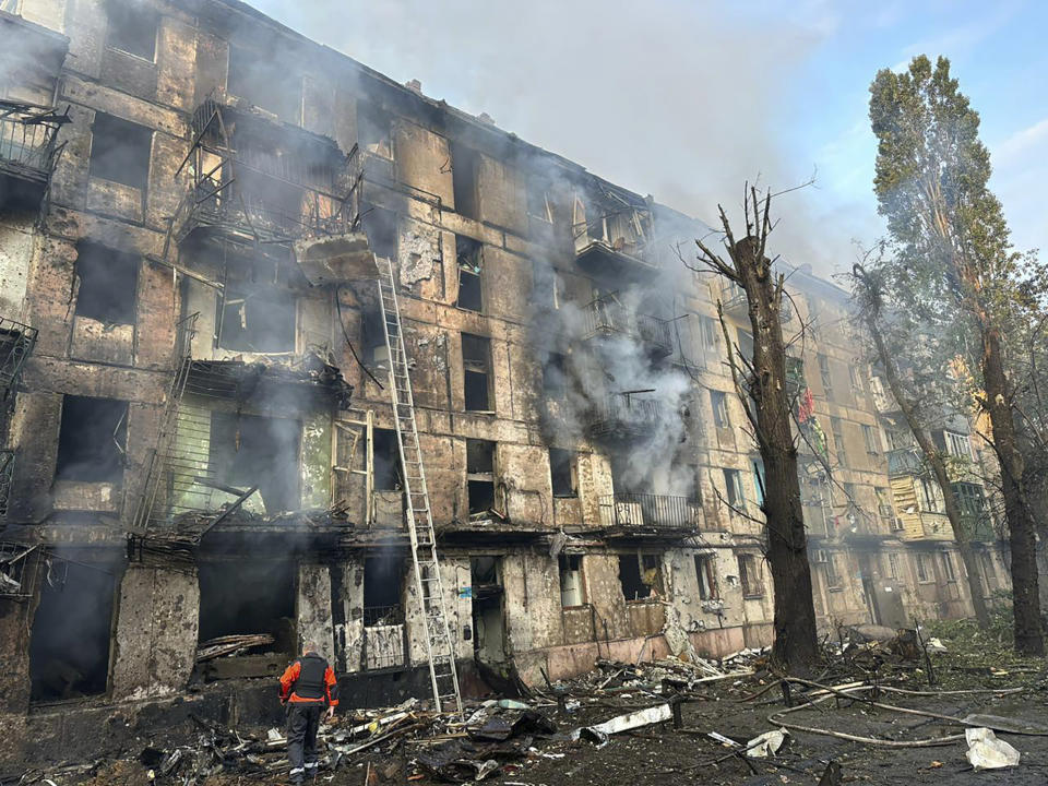 In this photo released by Dnipro Regional Administration, emergency workers extinguish a fire after missiles hit a multi-story apartment building in Kryvyi Rih, Ukraine, Tuesday, June 13, 2023. (Dnipro Regional Administration via AP)