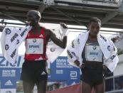 Winner Kenenisa Bekele (R) of Ethiopia and second-placed Wilson Kipsang of Kenia react after the men's competition at the Berlin marathon in Berlin, Germany, September 25, 2016. REUTERS/Fabrizio Bensch