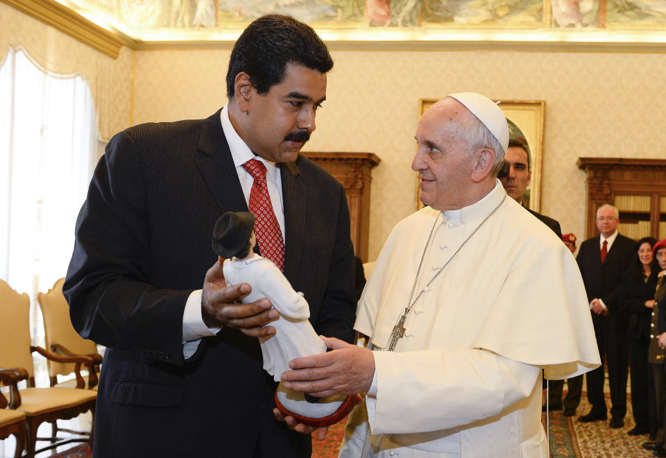 FILE - In this June 17, 2013 file pool photo, Venezuelan President Nicolas Maduro, left, gives Pope Francis a statuette of Venezuela's Jose' Gregorio Hernandez, a popular figure amongst Venezuelans whom Maduro expressed hope for his canonization, on the occasion of their private audience at the Vatican. Italian daily Corriere della Sera on Wednesday, Feb. 13, 2019 quoted from a letter it said Francis wrote to Maduro on Feb. 7, saying Francis indicated conditions aren't there for dialogue a few days after the socialist leader said in an interview that he had asked the pope to help launch talks to end the country’s political crisis. (Andreas Solaro, pool photo via AP, file)