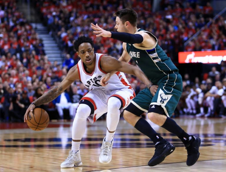 DeMar DeRozan of the Toronto Raptors dribbles the ball past Matthew Dellavedova of the Milwaukee Bucks in Game Two of the Eastern Conference quarter-finals, at Air Canada Centre in Toronto, Canada, on April 18, 2017