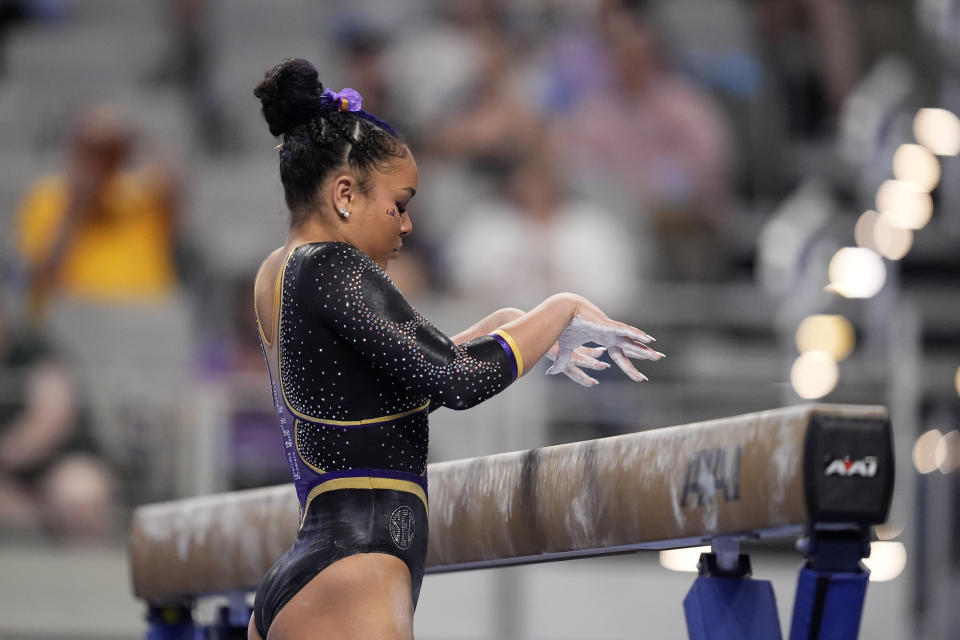 LSU's Konnor McClain begins her beam routine during the NCAA women's gymnastics championships in Fort Worth, Texas, Thursday, April 18, 2024. (AP Photo/Tony Gutierrez)