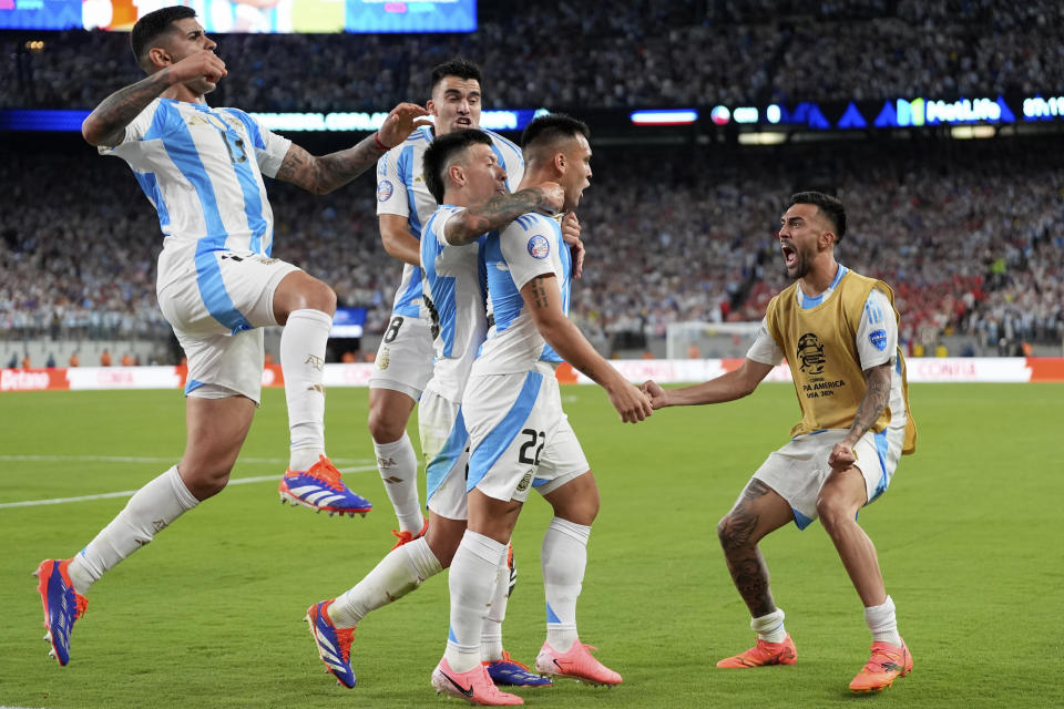 Argentina's Lautaro Martinez, second from right, celebrates scoring his side's opening goal against Chile during a Copa America Group A soccer match in East Rutherford, N.J., Tuesday, June 25, 2024.