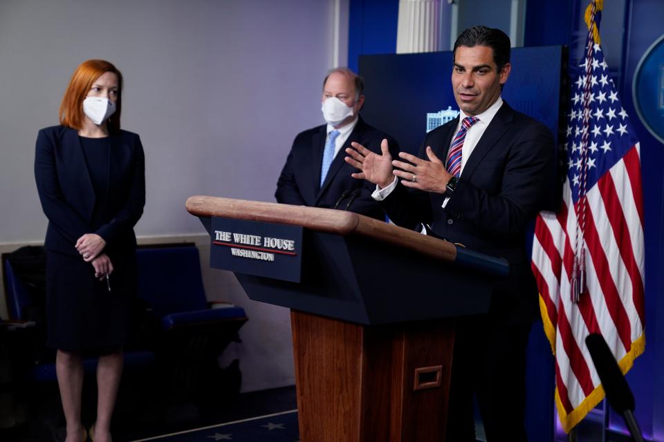 White House press secretary Jen Psaki, left, and Detroit mayor Mike Duggan, center, listen as Miami mayor Francis Suarez speaks during a press briefing at the White House, Friday, Feb. 12, 2021, in Washington. (AP Photo/Evan Vucci)