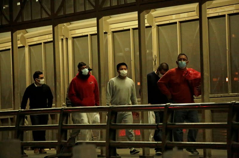 Migrants deported from the U.S. walk towards Mexico at Paso del Norte International border bridge, in this picture taken from Ciudad Juarez