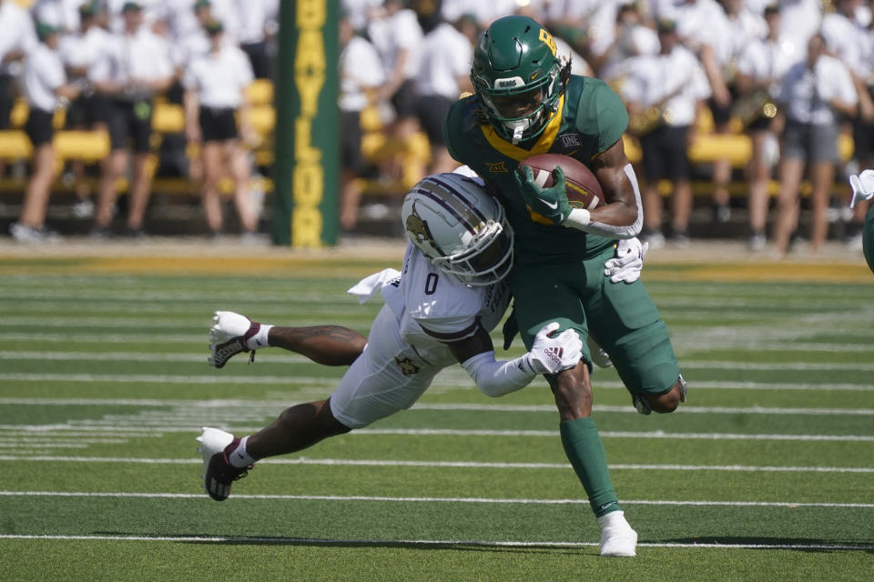 Baylor running back Craig Williams (0) runs against Texas State safety Jarron Morris (0 )during the first half of an NCAA college football game in Waco, Texas, Saturday, Sept. 17, 2022. (AP Photo/LM Otero)