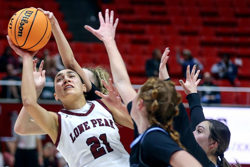 Lone Peak’s Naia Tanuvasa shoots as Westlake players guard her during a 6A girls quarterfinal basketball game at the Huntsman Center in Salt Lake City on Monday, Feb. 26, 2024. Lone Peak won 59-50. | Kristin Murphy, Deseret News