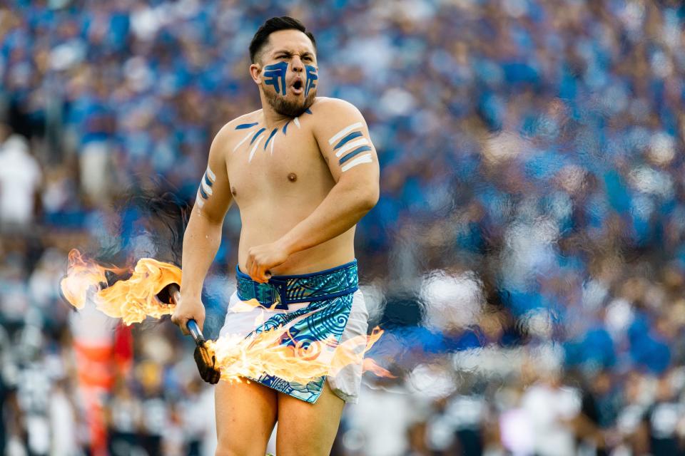 A fire dancer performs during the Brigham Young Cougars verses Southern Utah Thunderbirds football game at LaVell Edwards Stadium in Provo on Saturday, Sept. 9, 2023. | Megan Nielsen, Deseret News