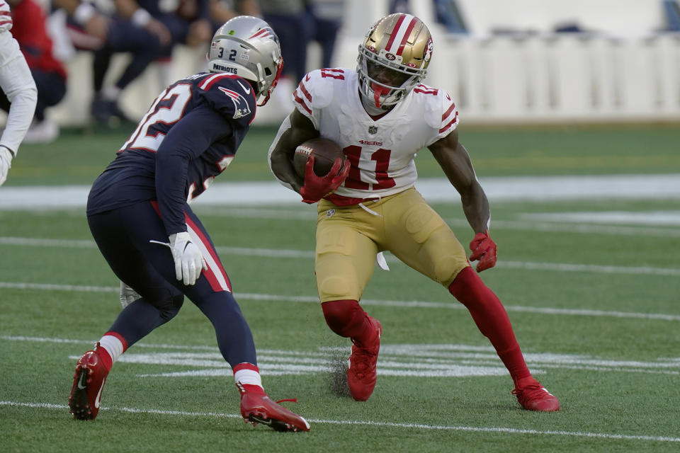 San Francisco 49ers wide receiver Brandon Aiyuk (11) runs after catching a pass as New England Patriots defensive back Devin McCourty (32) gives chase in the first half of an NFL football game, Sunday, Oct. 25, 2020, in Foxborough, Mass. (AP Photo/Steven Senne)