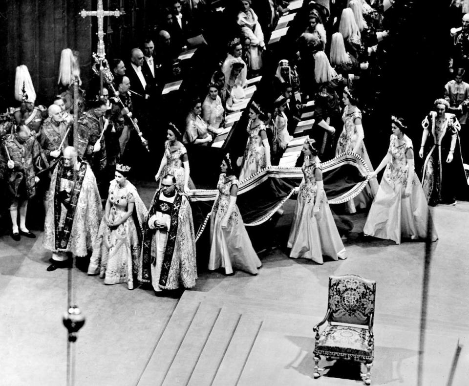 The Queen arrives at Westminster Abbey with her six Maids-of-Honour. She walks beside the Bishop of Durham (on her right) and the Bishop of Bath (PA/PA Wire)