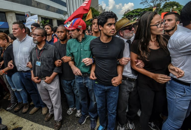 Venezuelan opposition leader Henrique Capriles (C) takes part in a march paying homage to student Juan Pablo Pernalete, killed a day before when he was hit by a gas grenade during a protest against President Maduro, in Caracas, on April 27, 2017