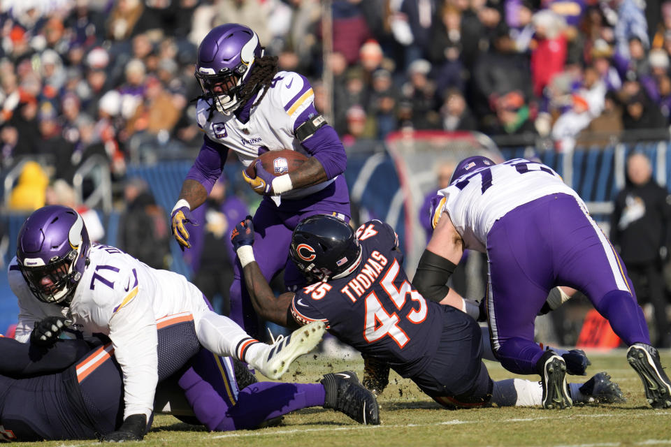 Minnesota Vikings running back Dalvin Cook (4) tries to break a tackle by Chicago Bears linebacker Joe Thomas (45) during the first half of an NFL football game, Sunday, Jan. 8, 2023, in Chicago. (AP Photo/Nam Y. Huh)