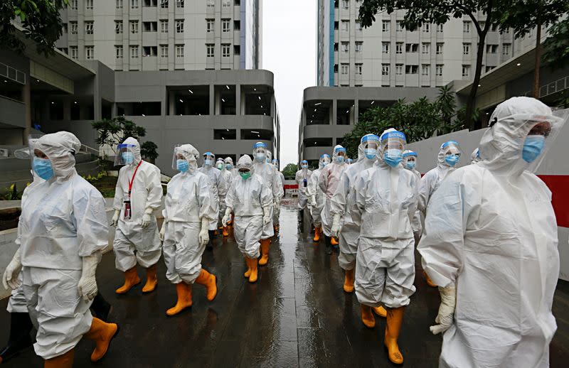 Healthcare workers prepare to treat patients at the emergency COVID-19 hospital in Athletes Village, Jakarta