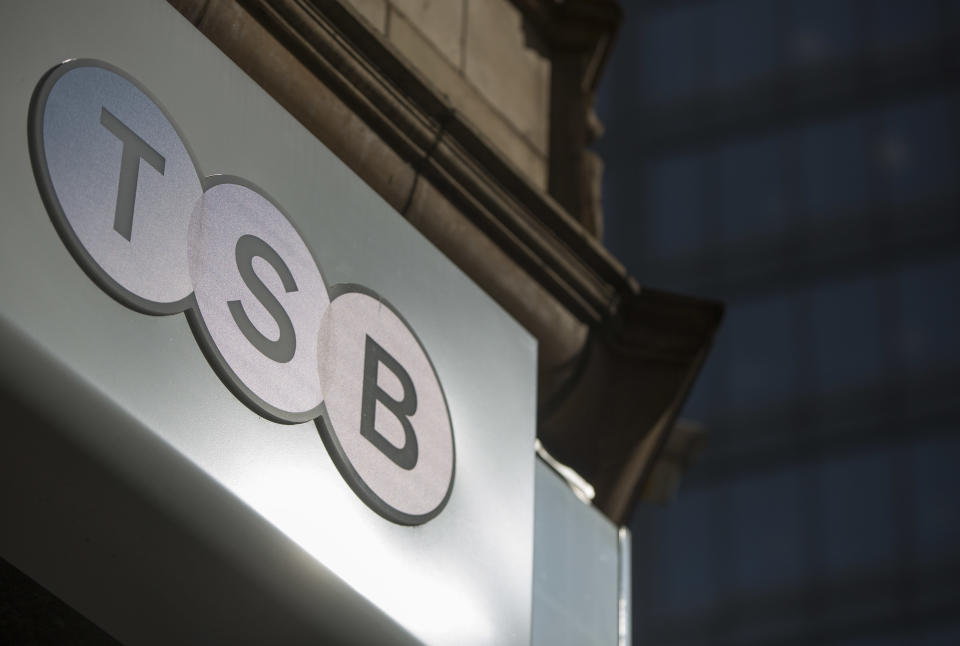 A sign is displayed outside a branch of the TSB bank in central London March 12, 2015. British challenger bank TSB has received a takeover approach from Banco Sabadell, valuing the business at about $2.6 billion and sending its shares soaring by nearly a quarter. REUTERS/Neil Hall (BRITAIN - Tags: BUSINESS)