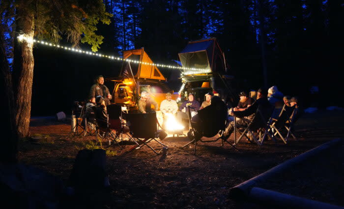 A V/O group talks by the fire.